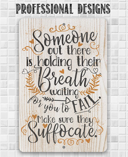 Metal sign with 'Someone out there is holding their Breath' script and leaf motif