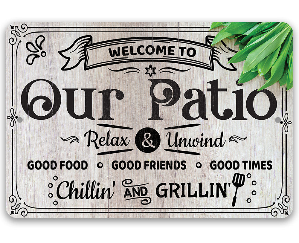 Metal patio welcome sign reading "Our Patio" with "Relax & Unwind" and grilling text.