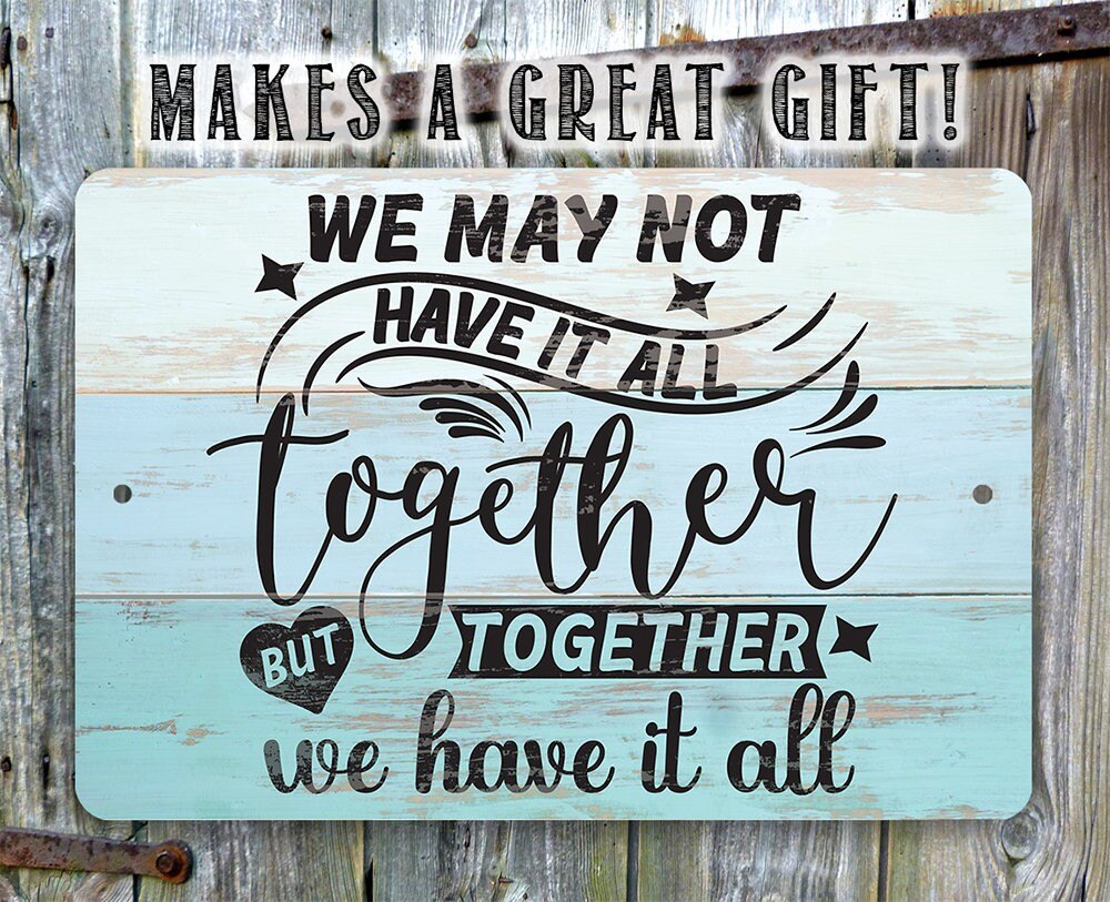 Light blue metal sign with quote: 'We may not have it all, but together we have it all'.