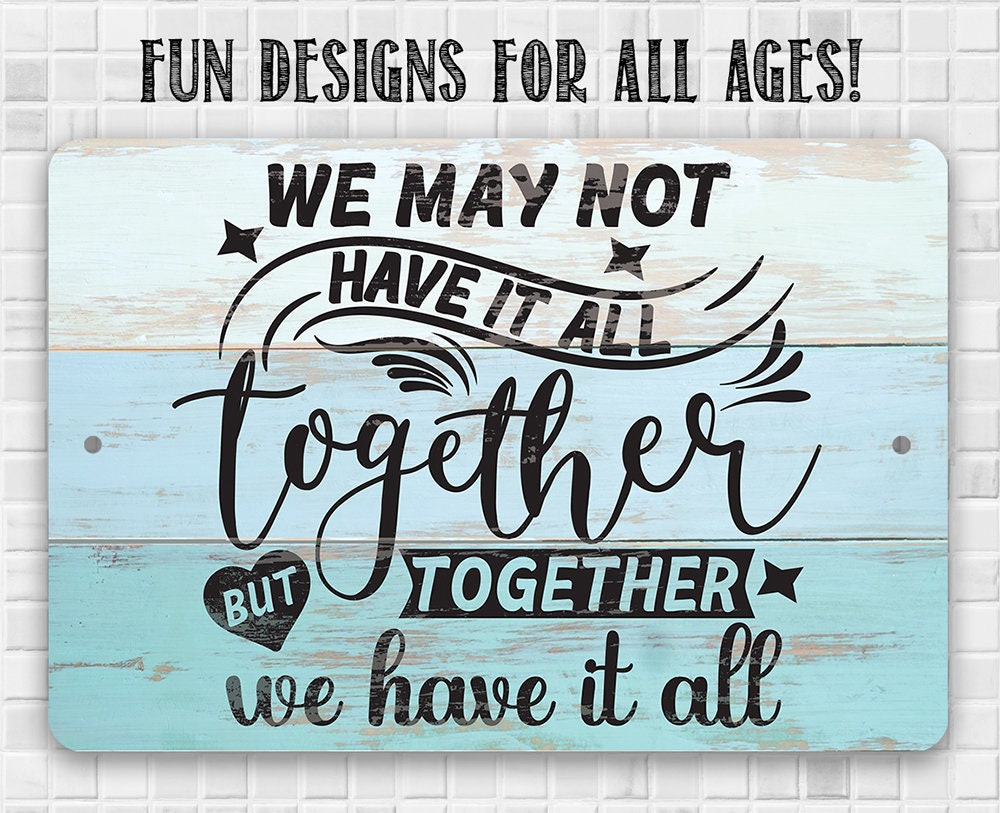 Light blue metal sign with 'FUN DESIGNS FOR ALL AGES!' and 'We may not have it all' quote.
