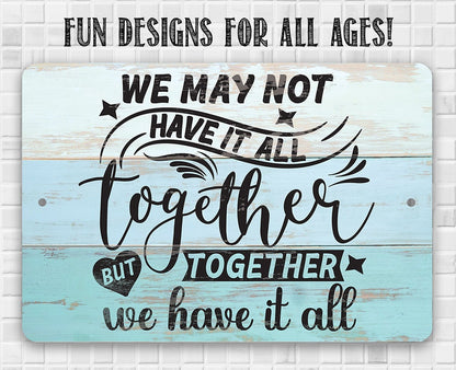 Light blue metal sign with 'FUN DESIGNS FOR ALL AGES!' and 'We may not have it all' quote.